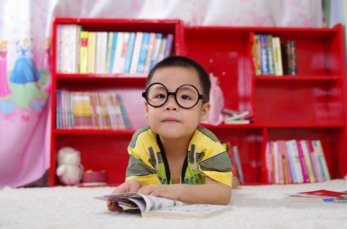 Child reading a book at Small Talk Pediatric Therapy