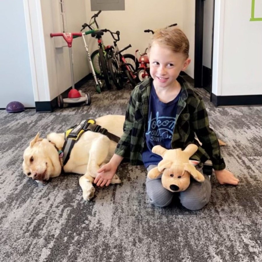 Small Talk Pediatric Therapy client with therapy dog